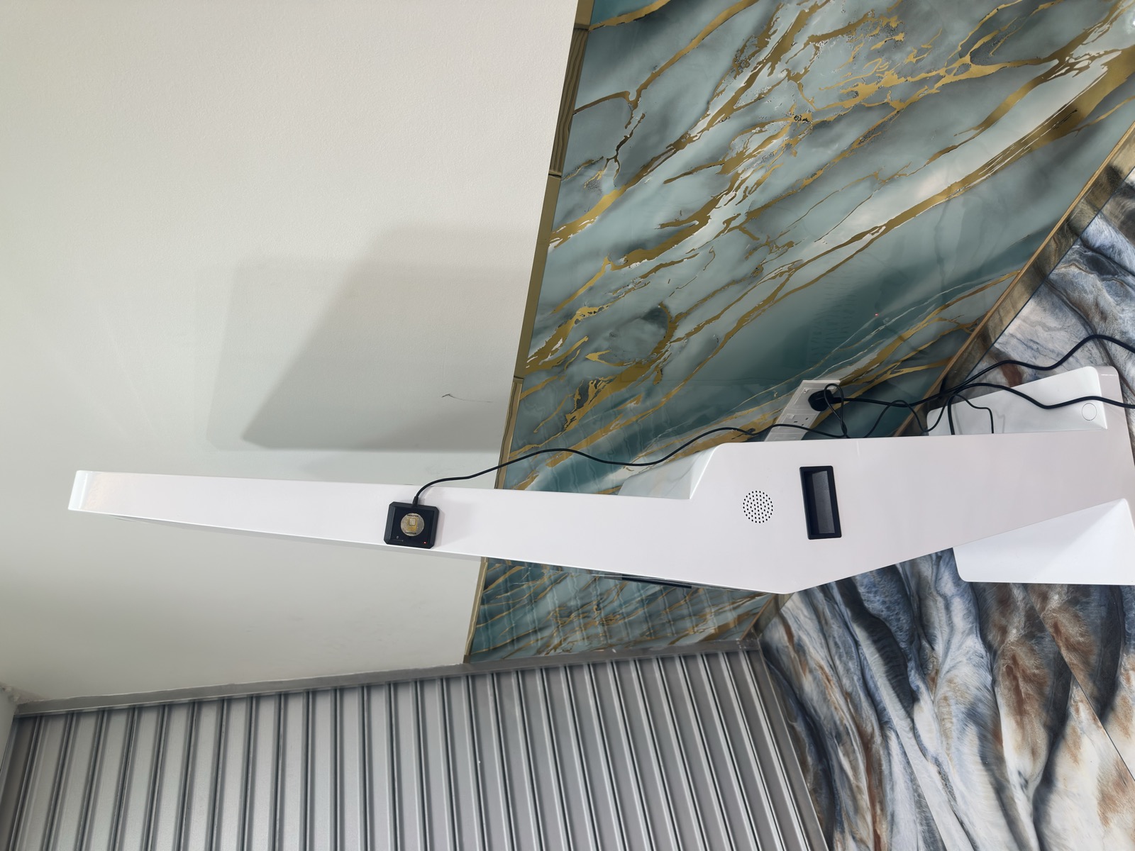 MoVo-X kiosk rear view — speaker grill, cable management