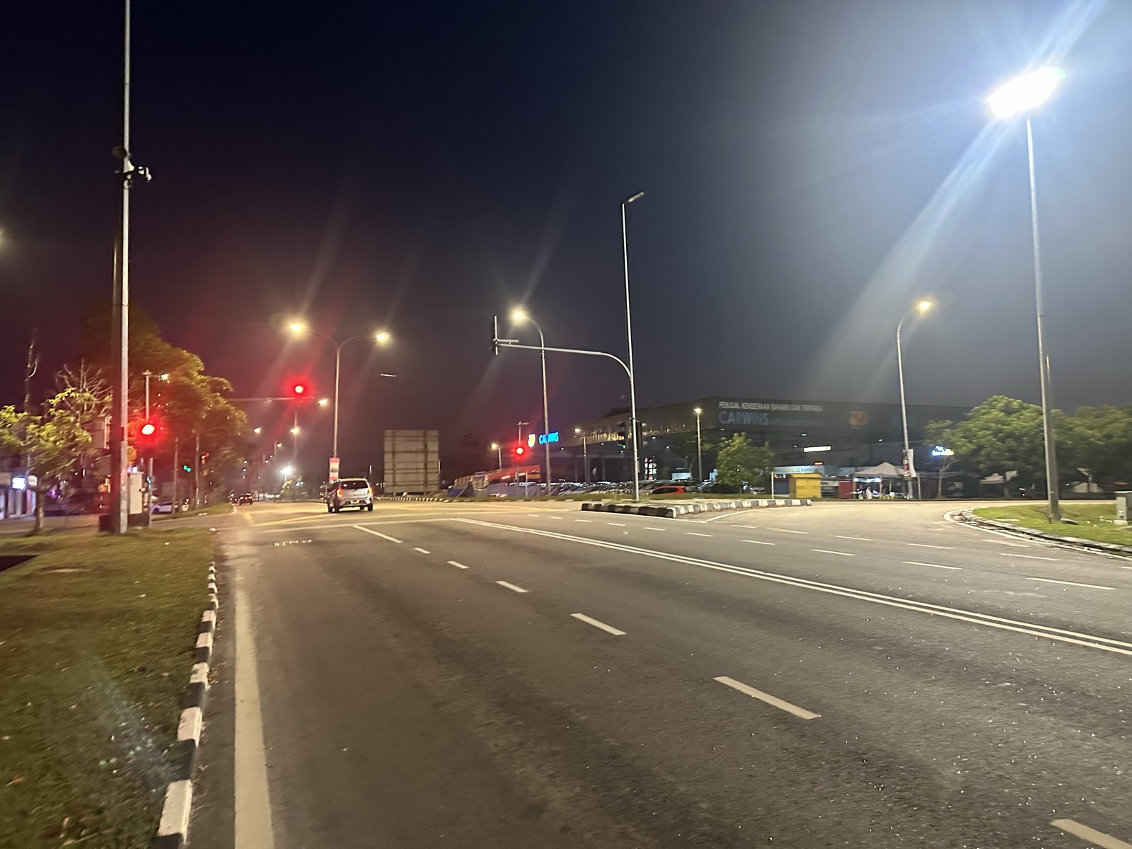 Highway intersection at night — empty lanes, traffic lights