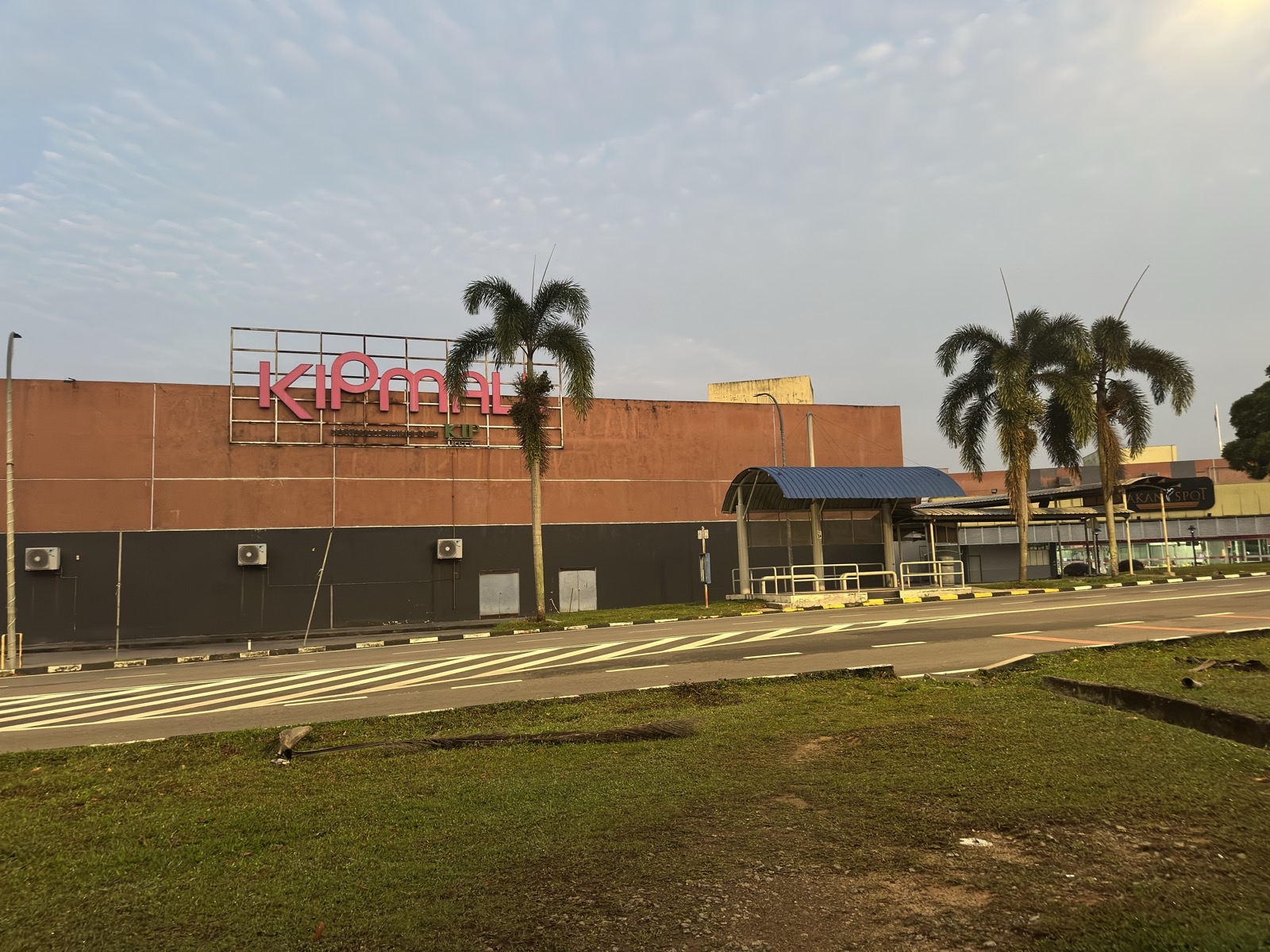 KIP Mall building at dawn — flat retail architecture against morning sky