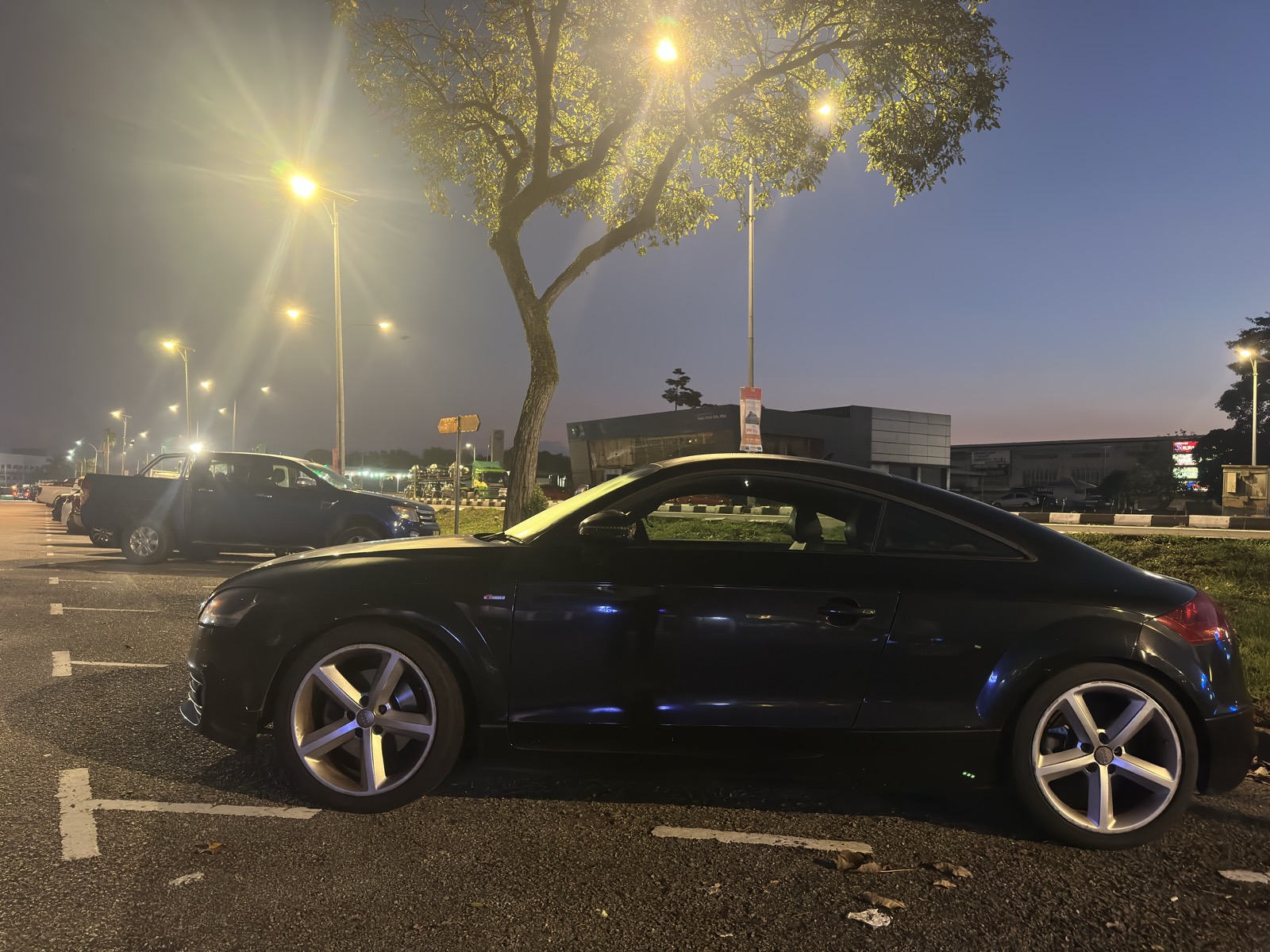 Black Audi TT at night under JB street lights — chrome wheels, perfect silhouette