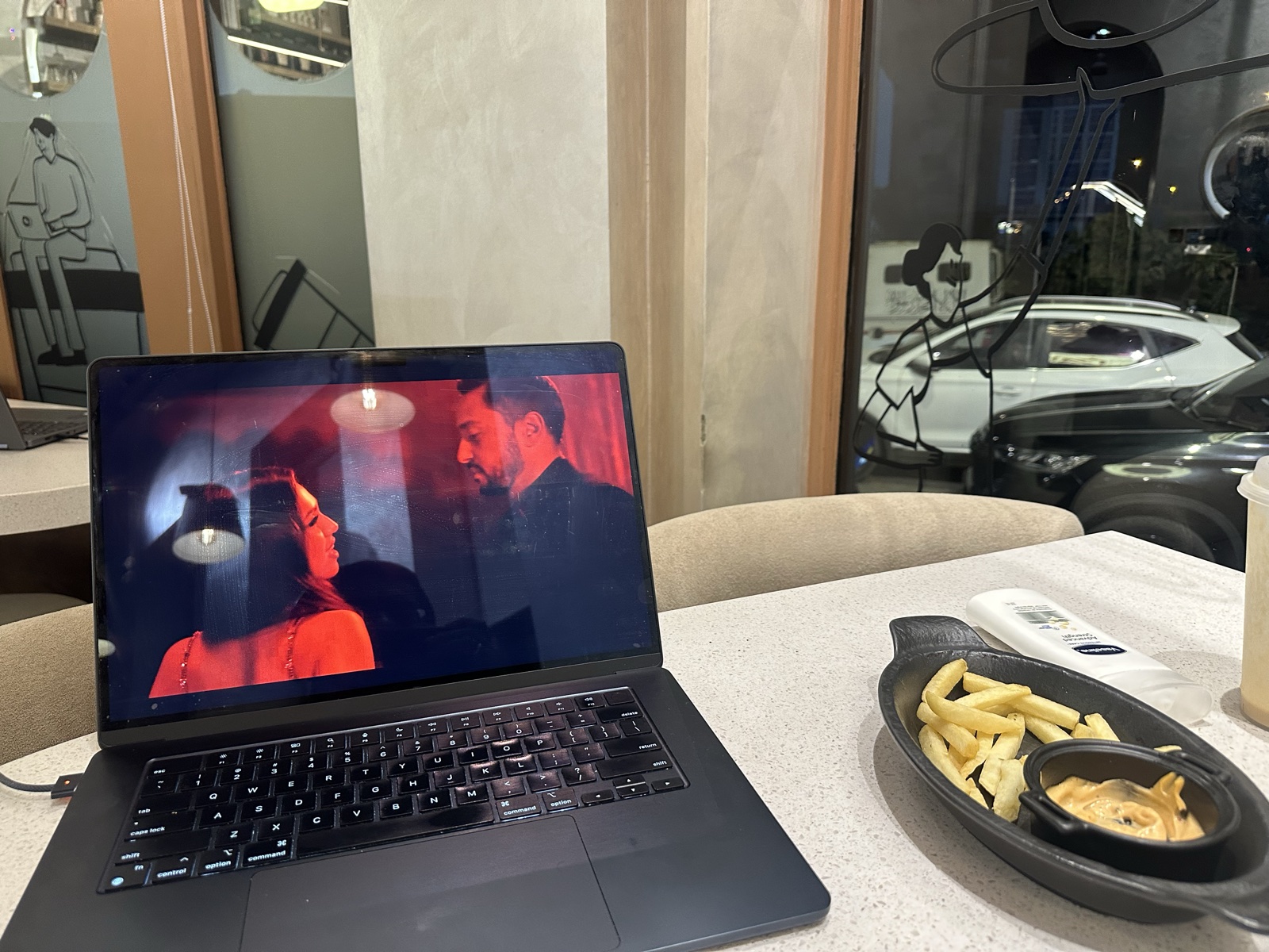 MacBook open in a café — back in Karachi