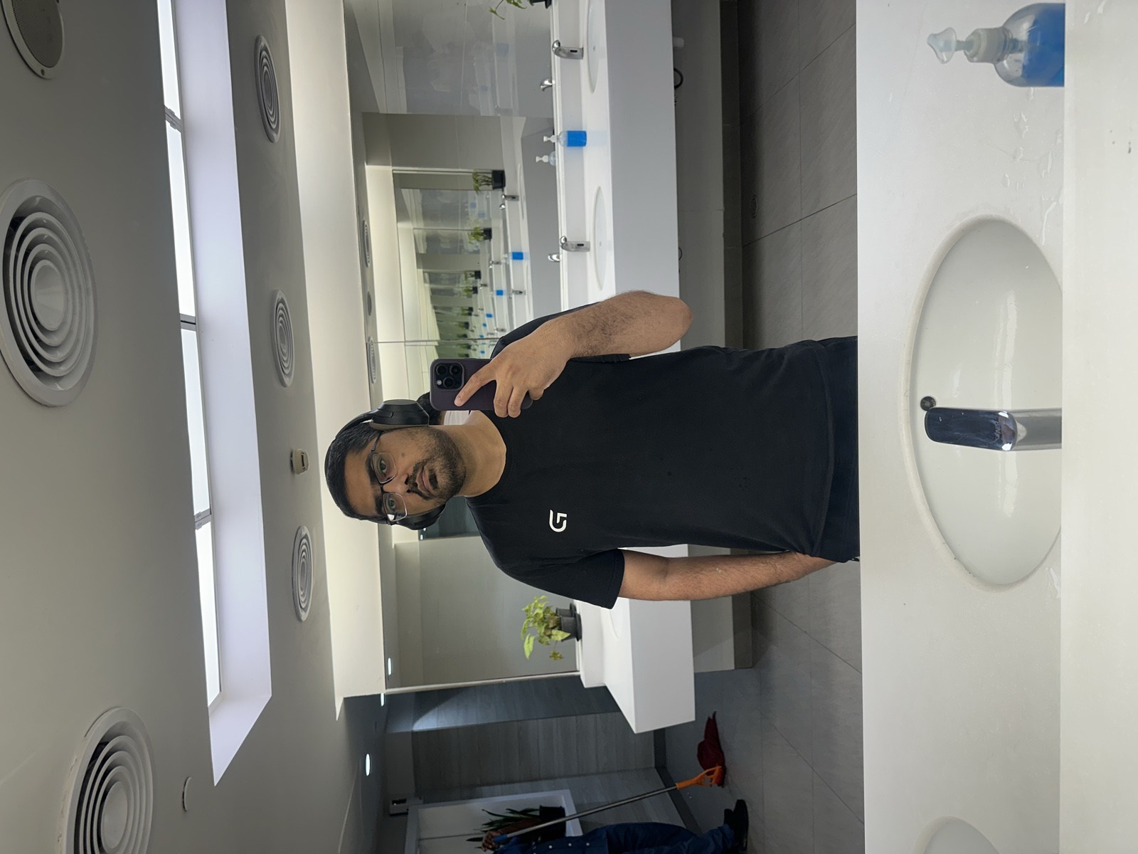 Bathroom selfie — headphones on, back in Karachi mode