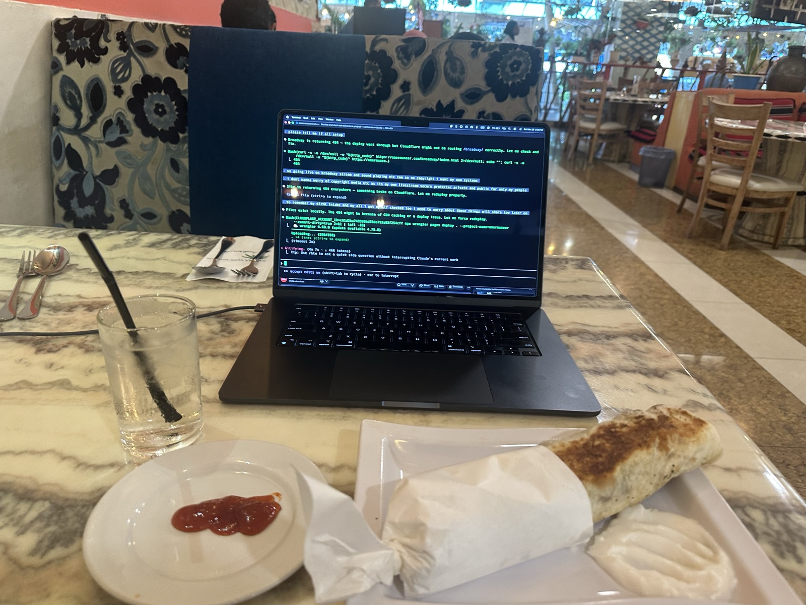 MacBook and spring rolls at restaurant