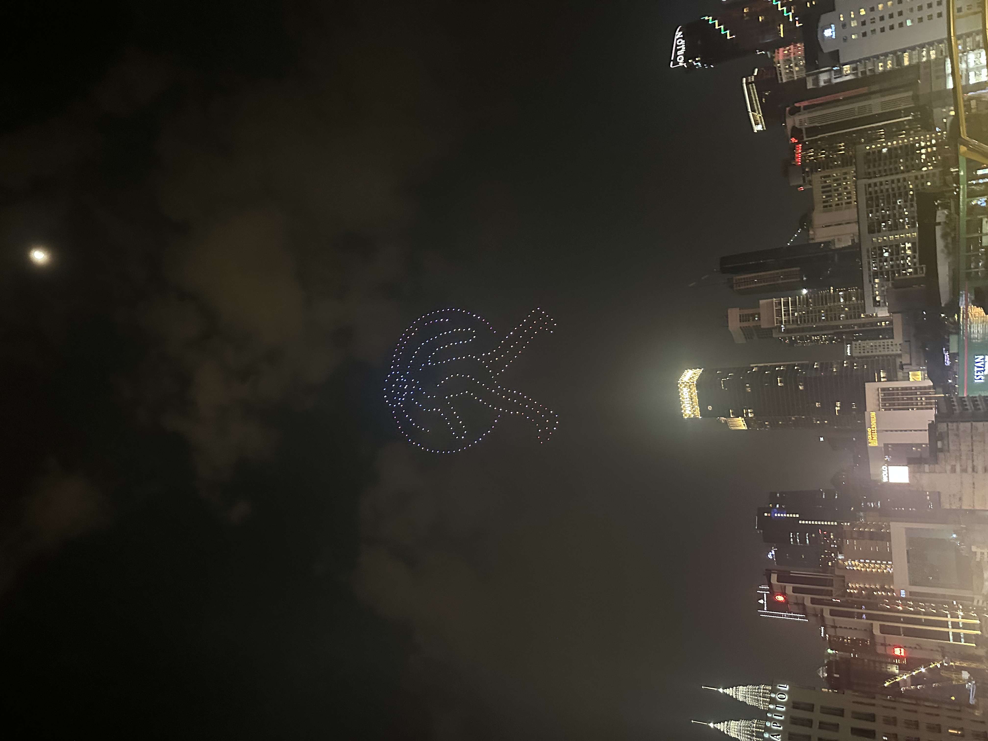 KL drone show with moon over the skyline