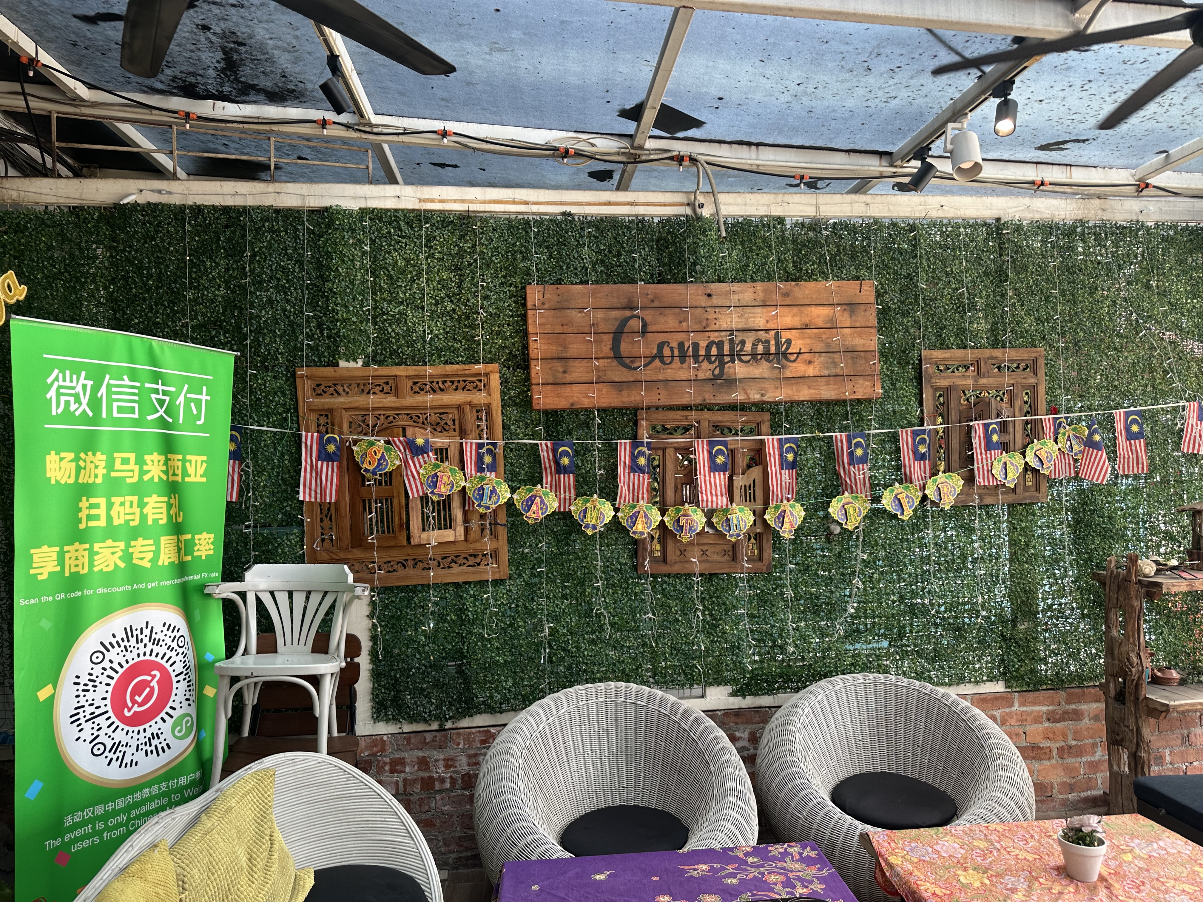 Congkak restaurant sign on wooden board with Malaysian flags