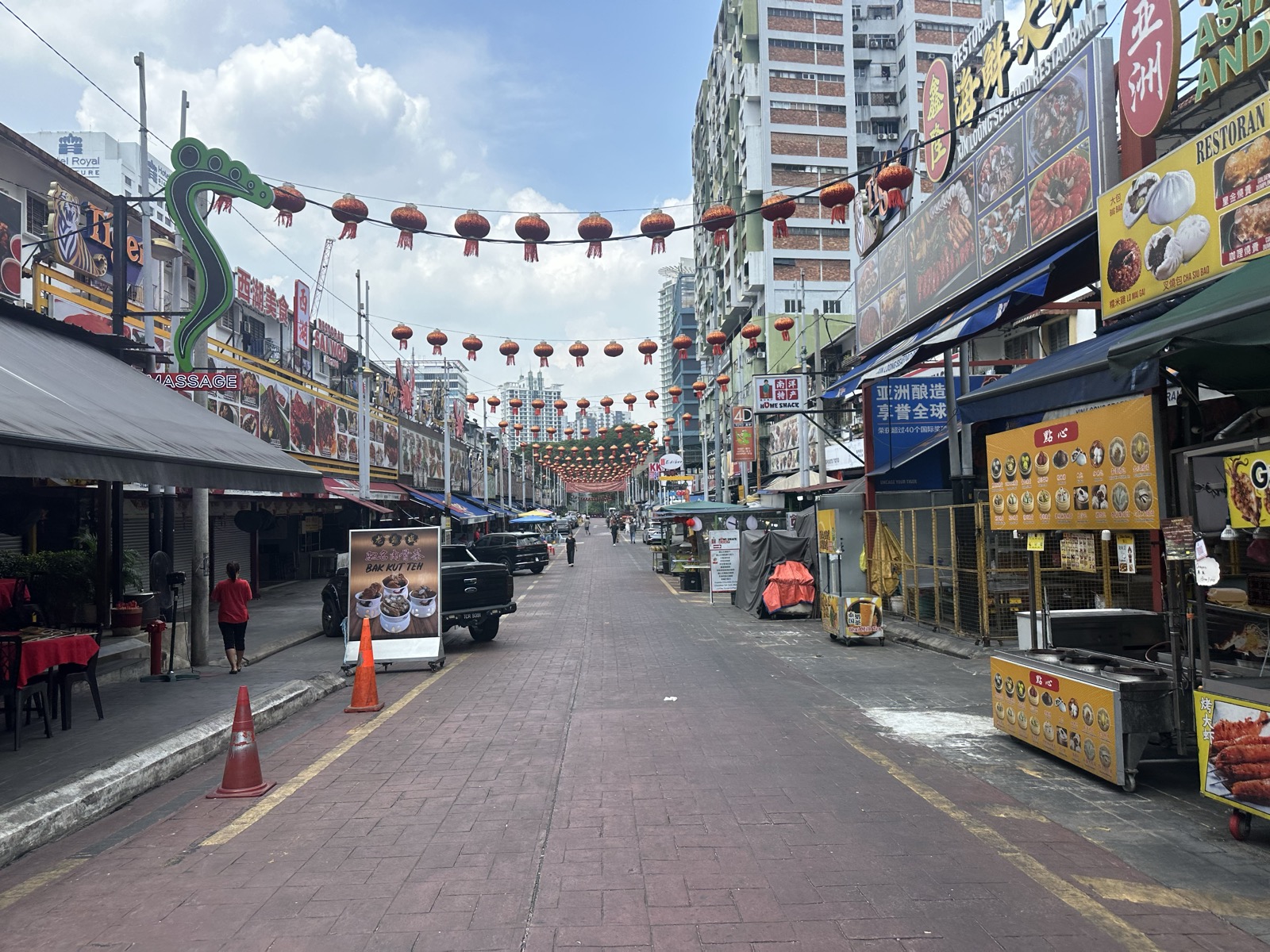 Petaling Street KL Chinatown — red lanterns strung across, Chinese shophouses, food stalls — Day 4