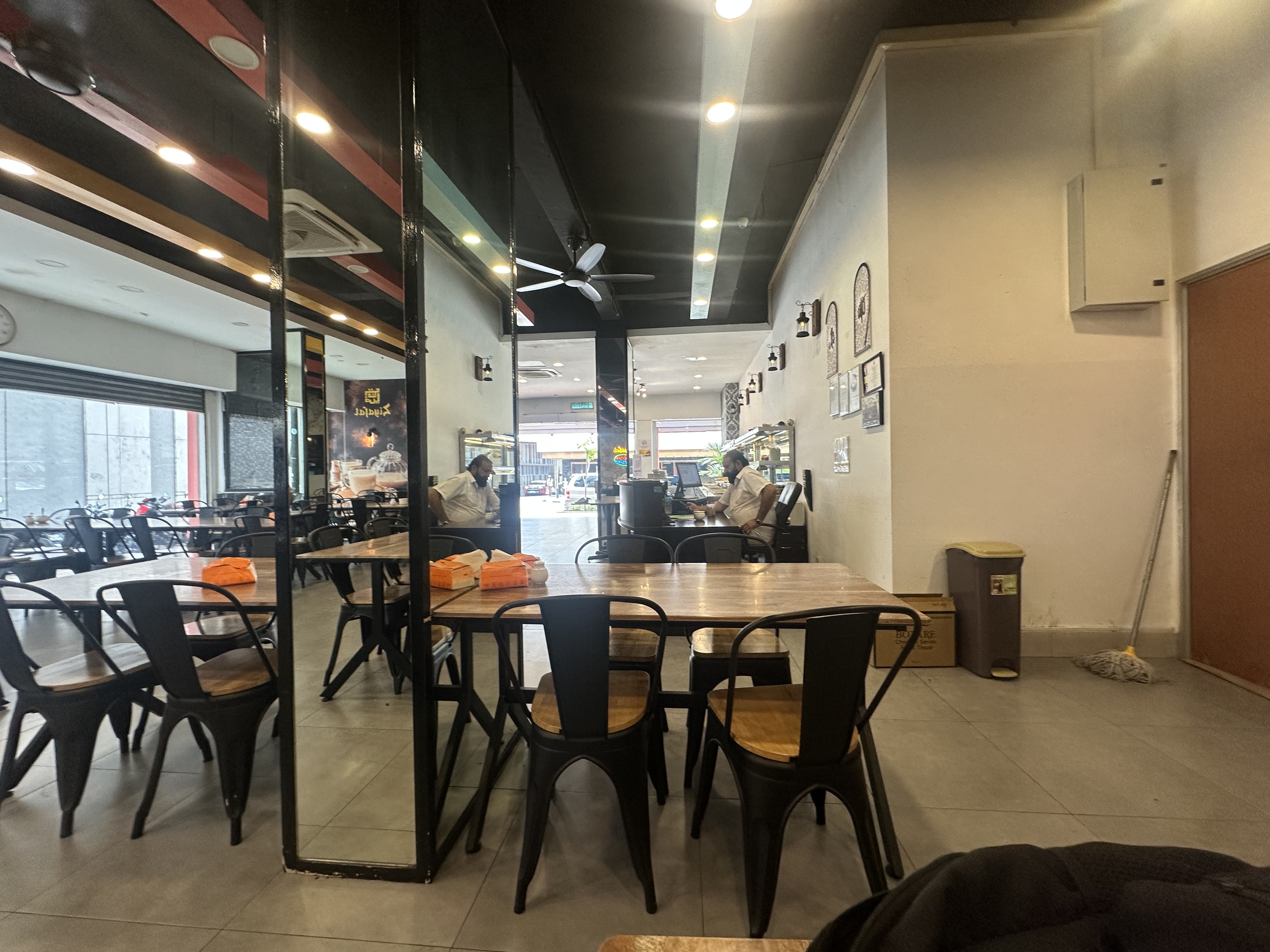 Ziafat restaurant interior — industrial chairs, wooden tables