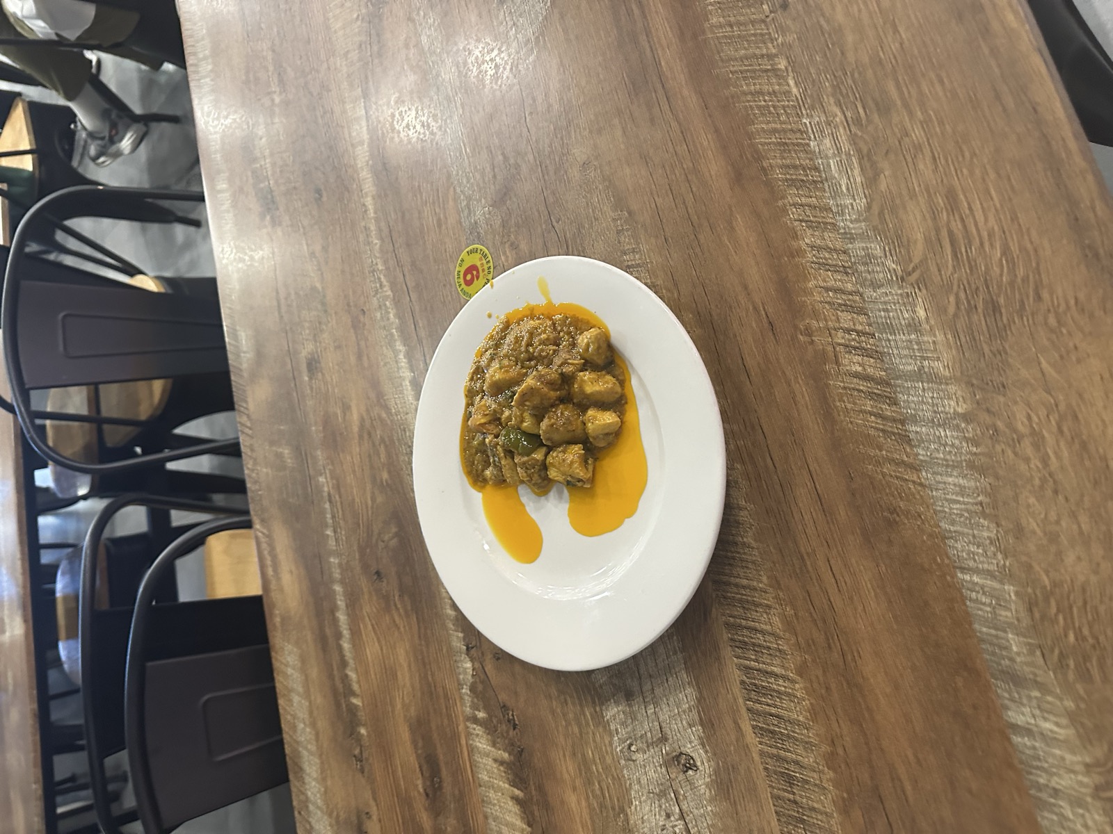 Afghan chicken curry — yellow-orange sauce, small white plate — evening, Day 4
