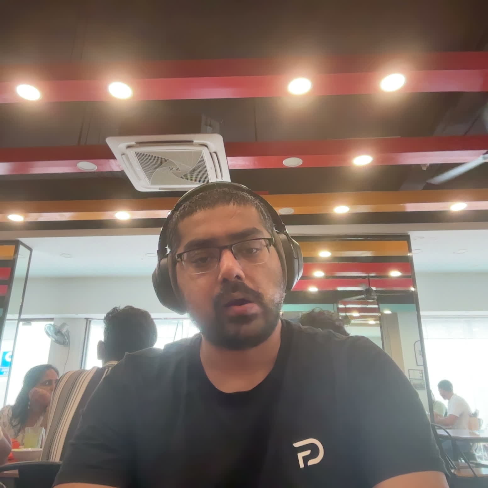 Webcam capture at Ziafat restaurant — red ceiling beams, recessed lights, AC unit