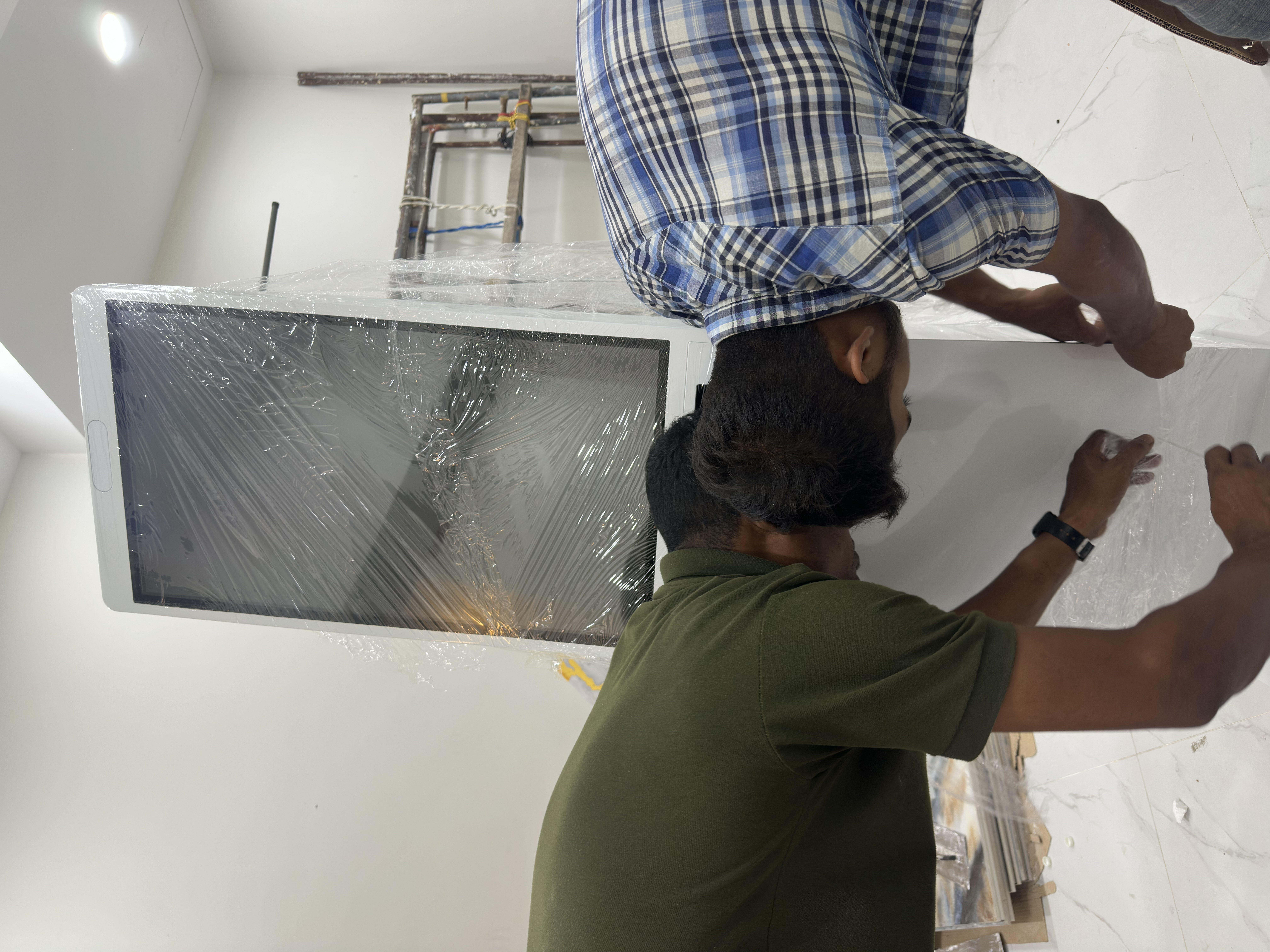 Dr. Prabagaran and CEO Haadi lifting the MoVo-X kiosk together