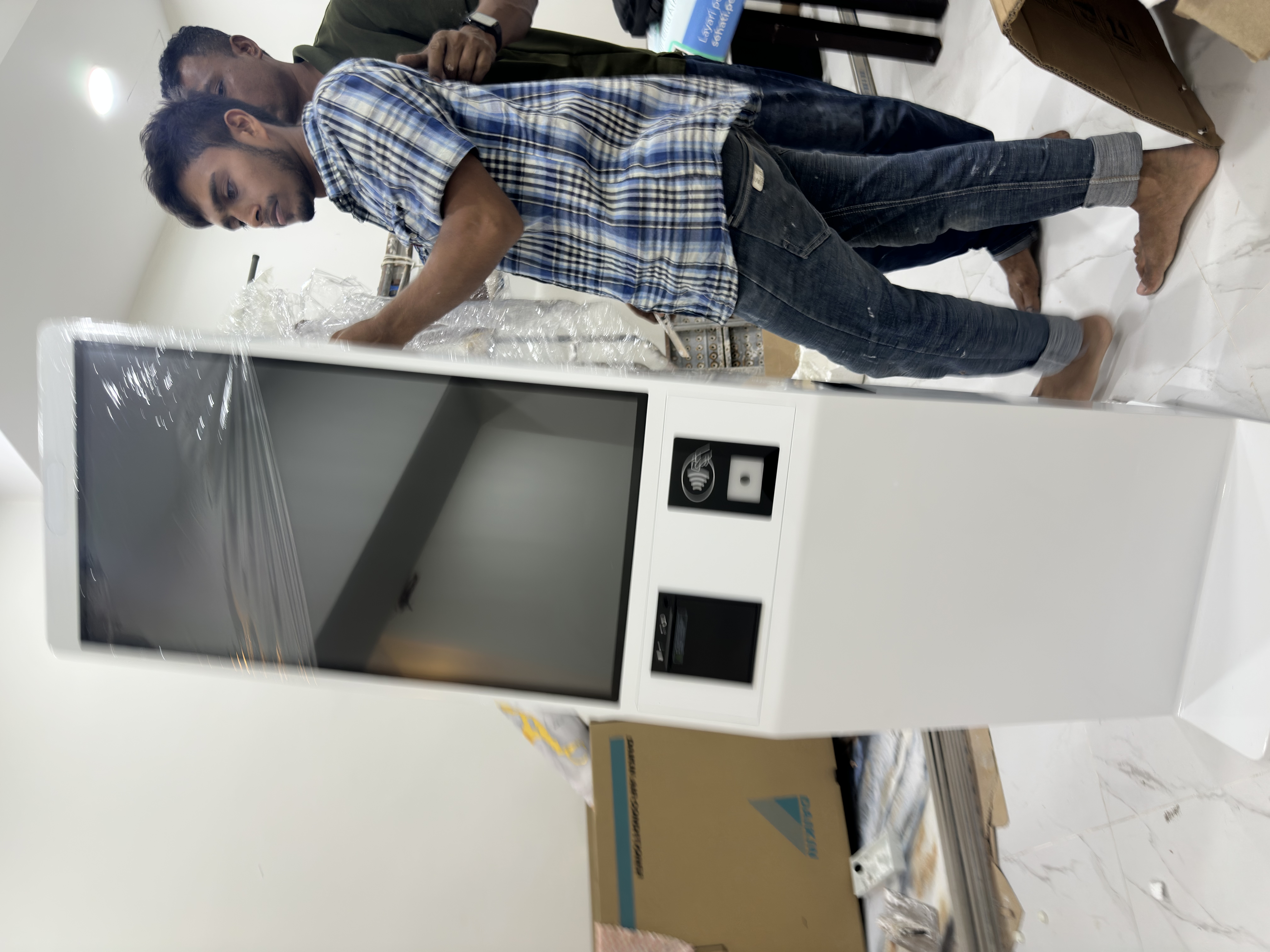 CEO Haadi standing next to the assembled MoVo-X kiosk at Klinik Muhibbah