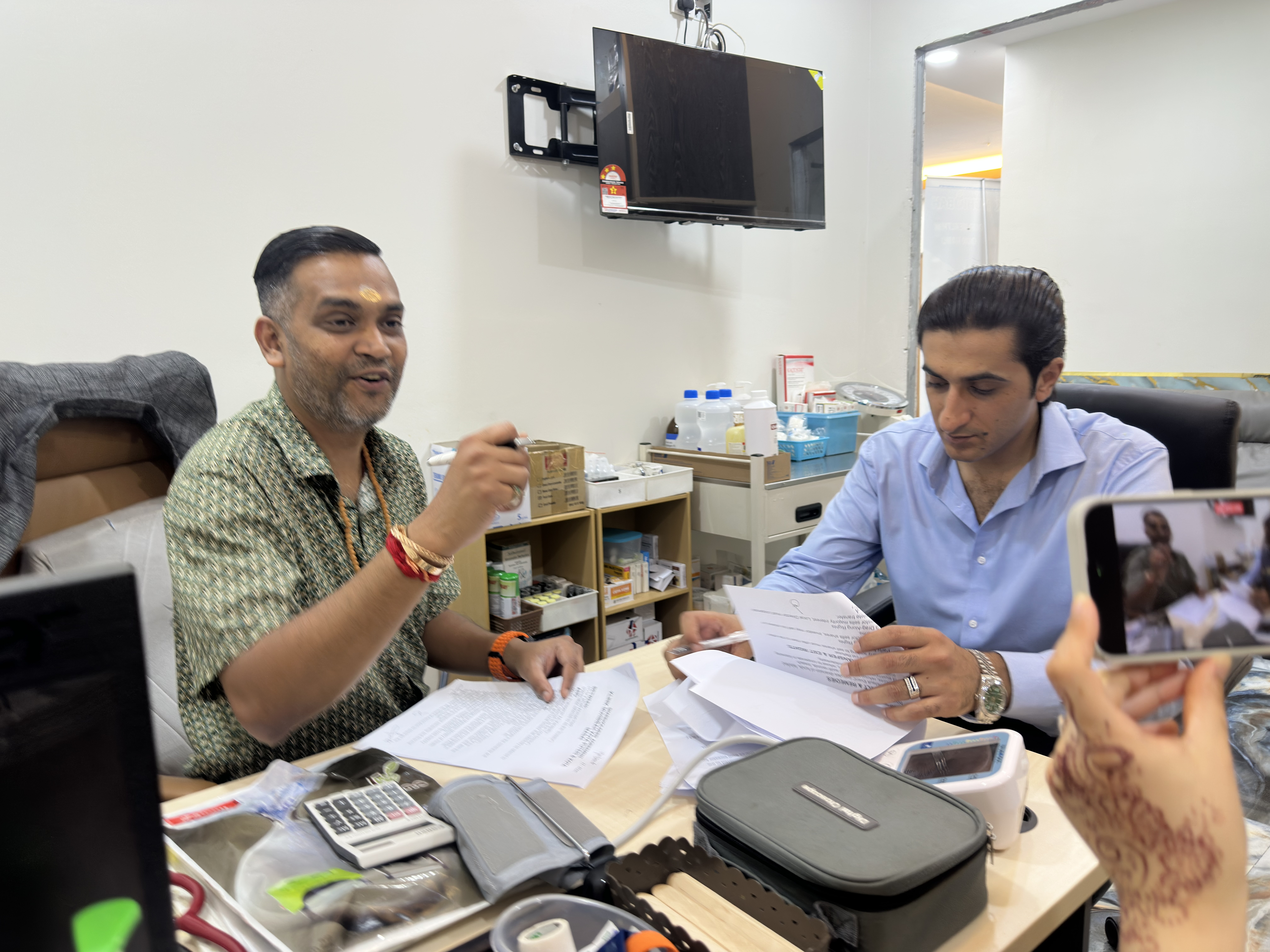 Dr. Prabagaran smiling proudly after signing