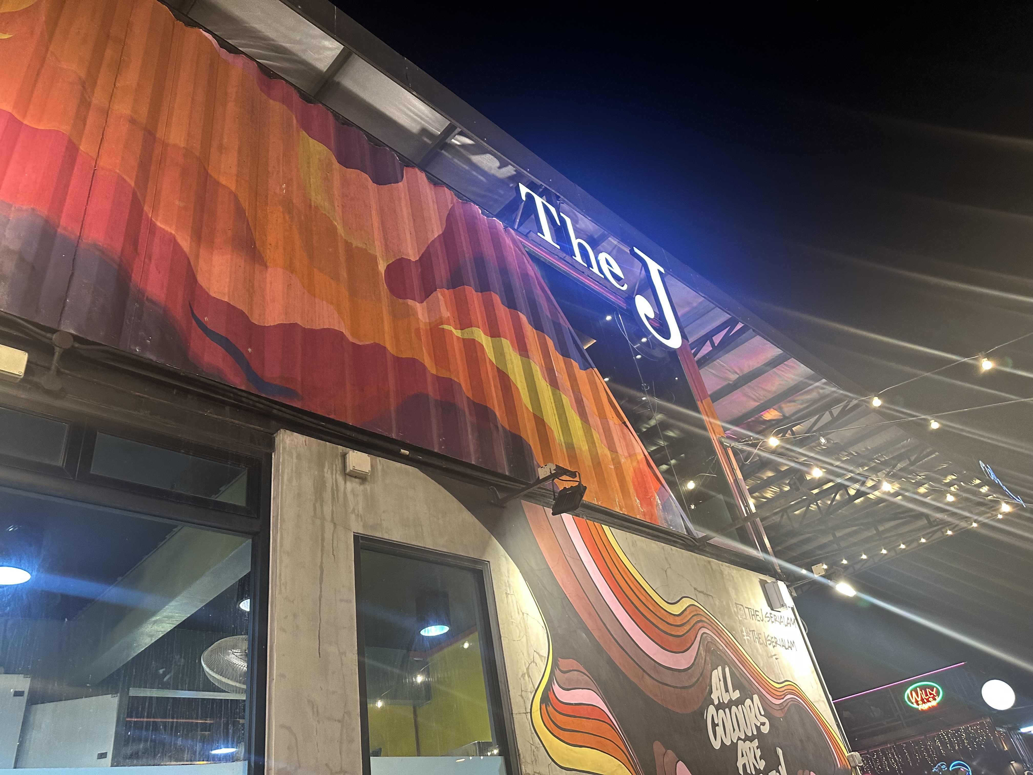 The J entrance sign — neon retro painted exterior