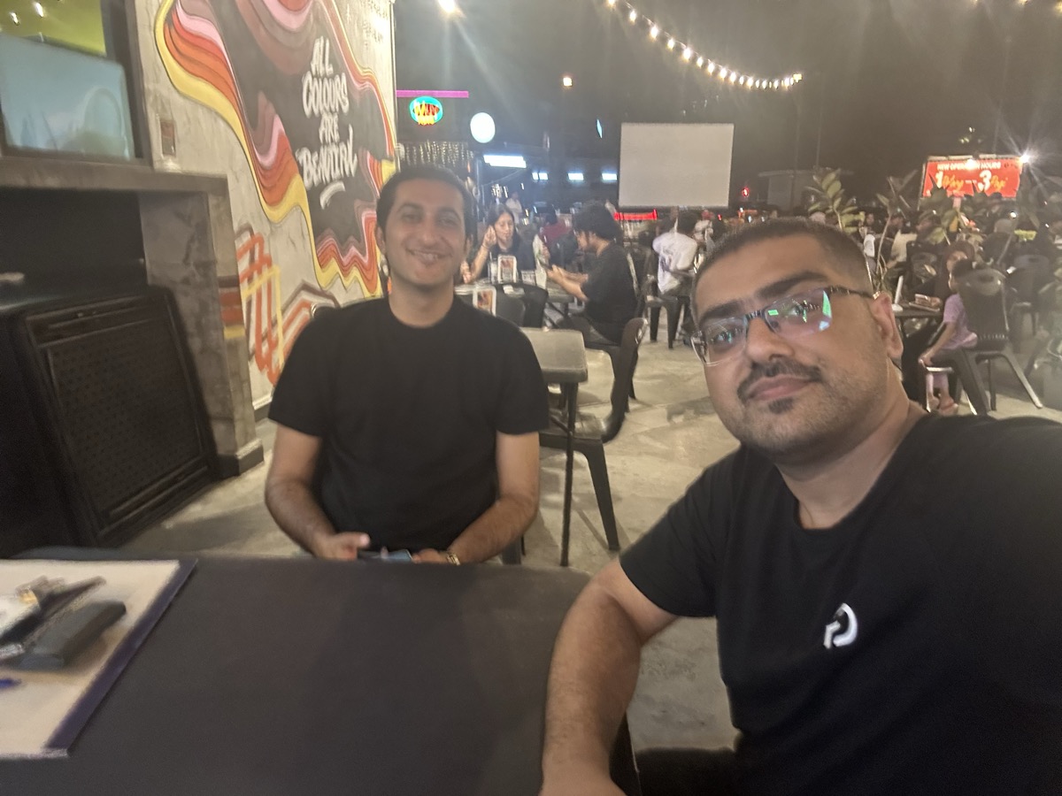 Omer and Haadi selfie at car cafe — All Colours Are Beautiful mural