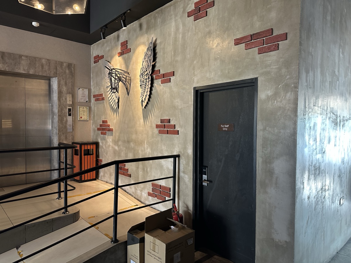 Industrial loft hotel — angel wings wall art, concrete walls