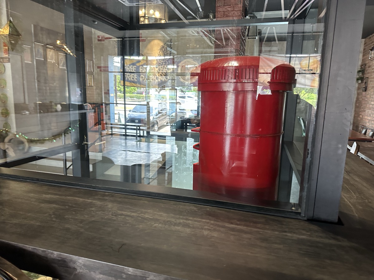 Red fire hydrant behind glass — industrial decor