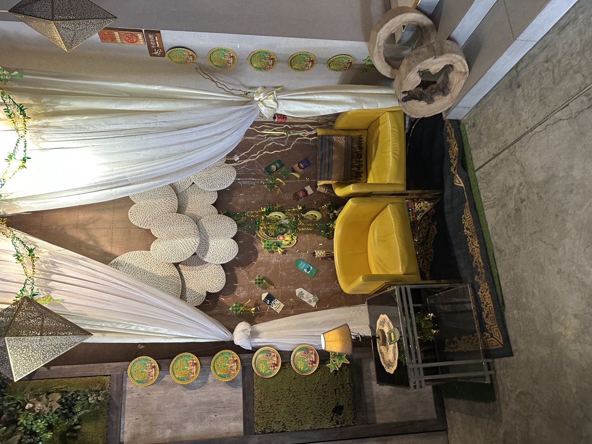 Hotel lobby — white drapes, yellow chairs, decorated sitting area