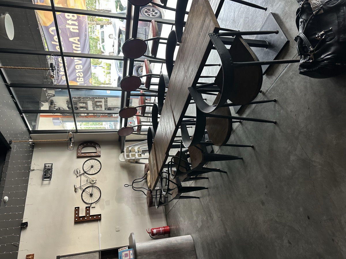 Empty cafe interior — chairs stacked, industrial style