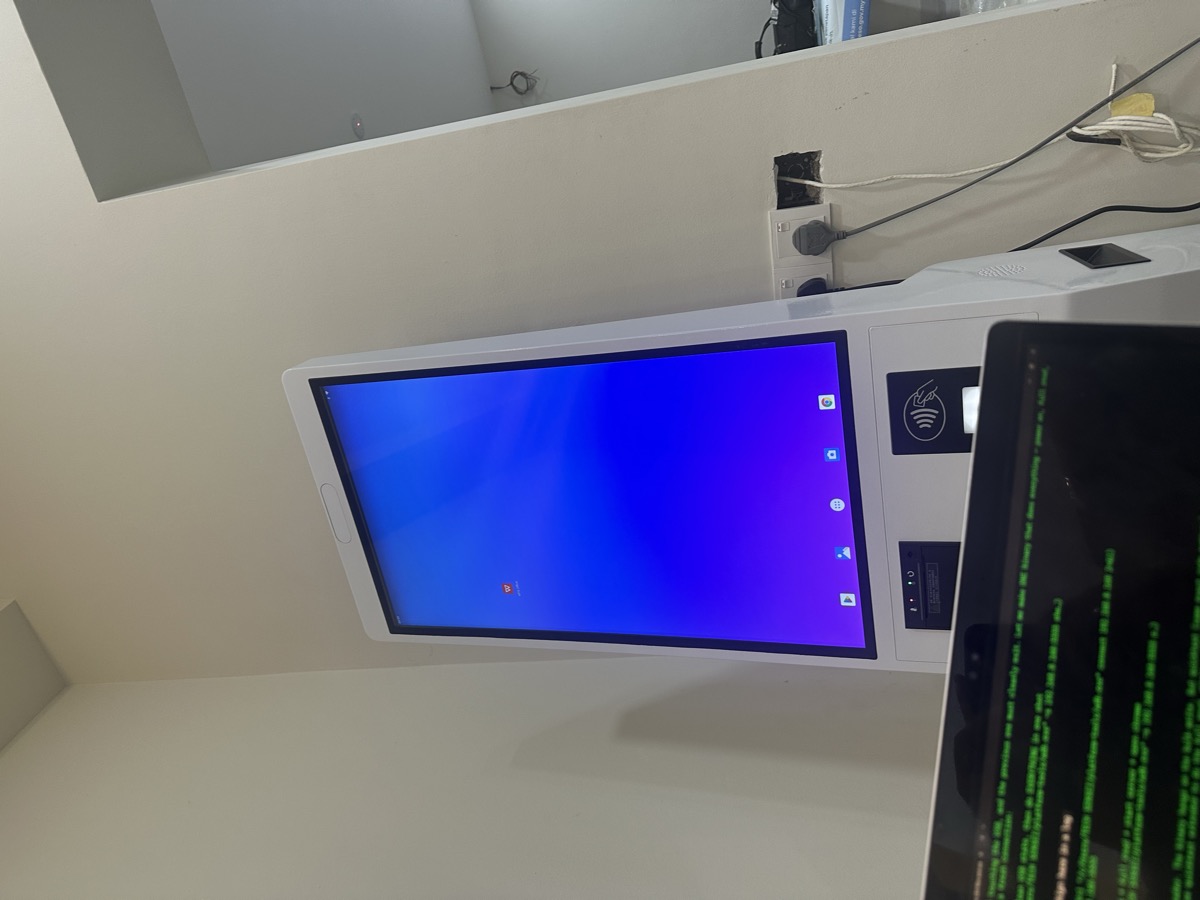 MoVo-X kiosk running at Klinik Muhibbah with MacBook terminal beside it