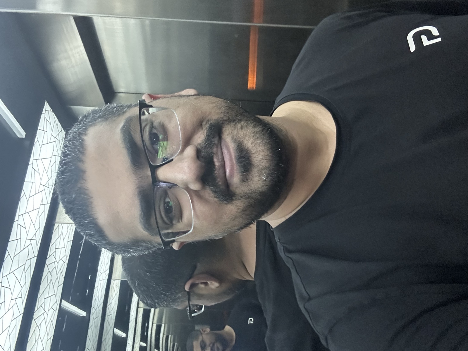 Admin selfie at JB restaurant — black t-shirt, glasses